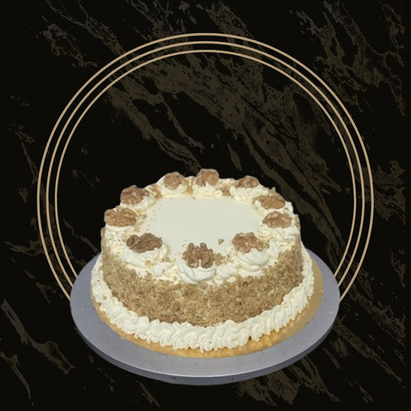 Classic carrot cake with cream cheese frosting and nut topping from The Bakers Shop in Birmingham