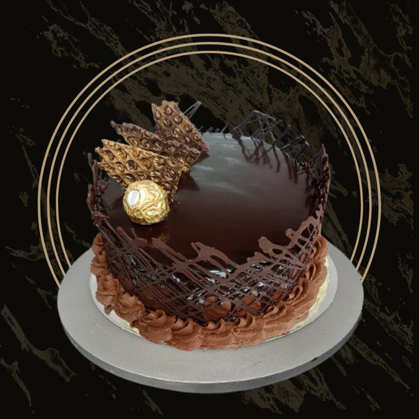 Chocolate cake with glossy ganache drip and decorative swirls from The Bakers Shop in Birmingham