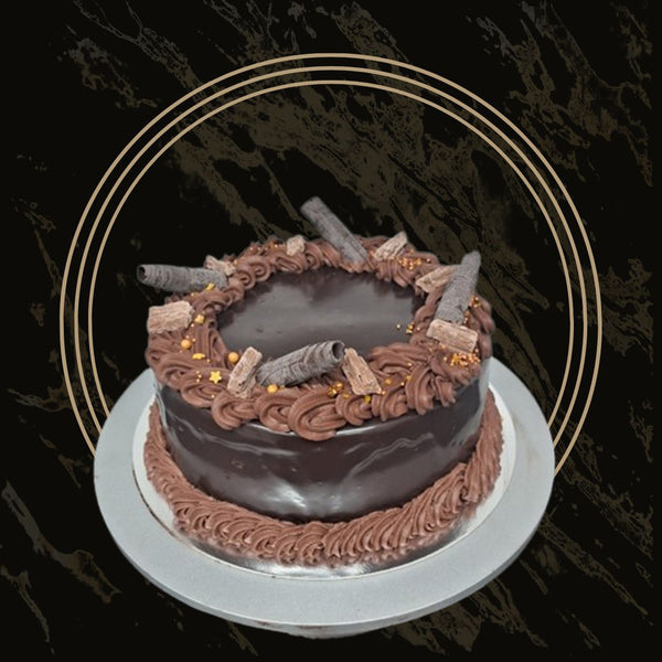 Round chocolate cake with piped edges and chocolate sprinkles from The Bakers Shop in Birmingham