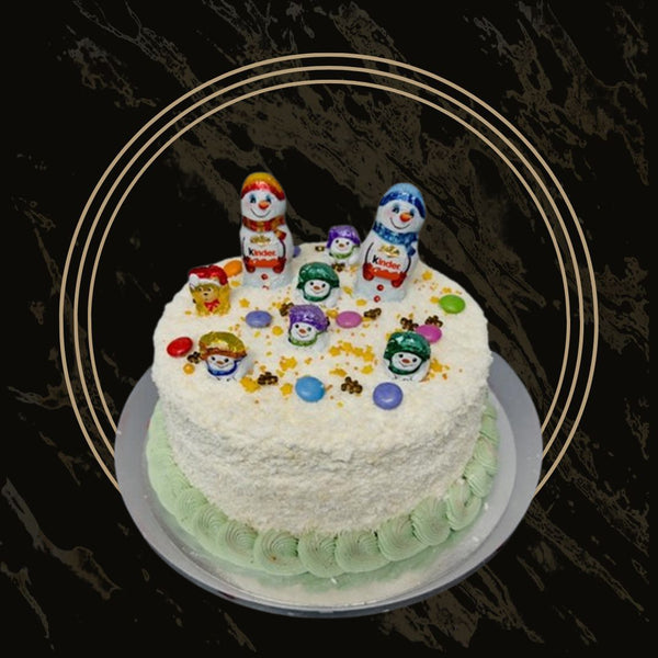 Festive Christmas cake with gingerbread house decoration and snowy frosting from The Bakers Shop in Birmingham