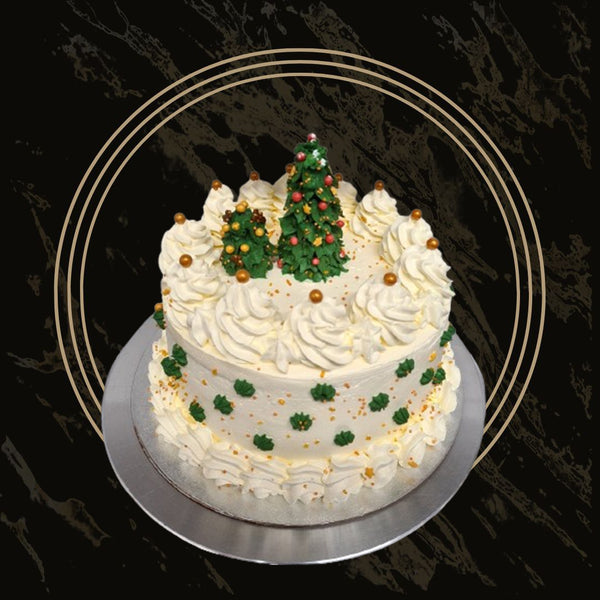 Elegant Christmas cake with gold stars and smooth white fondant from The Bakers Shop in Birmingham
