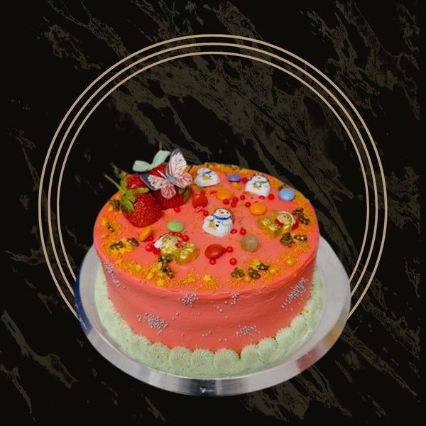 Christmas cake decorated with white snowflakes and red icing from The Bakers Shop in Birmingham