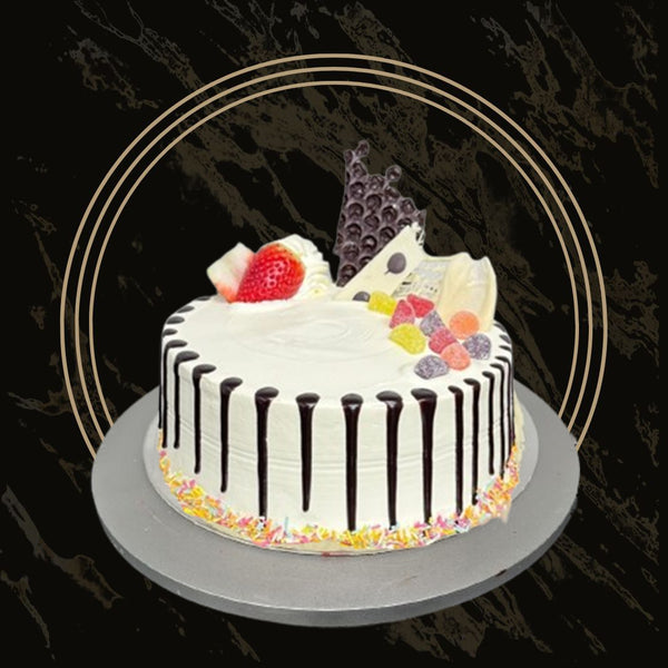 Themed fancy birthday cake with gold pearls and layered frosting from The Bakers Shop in Birmingham