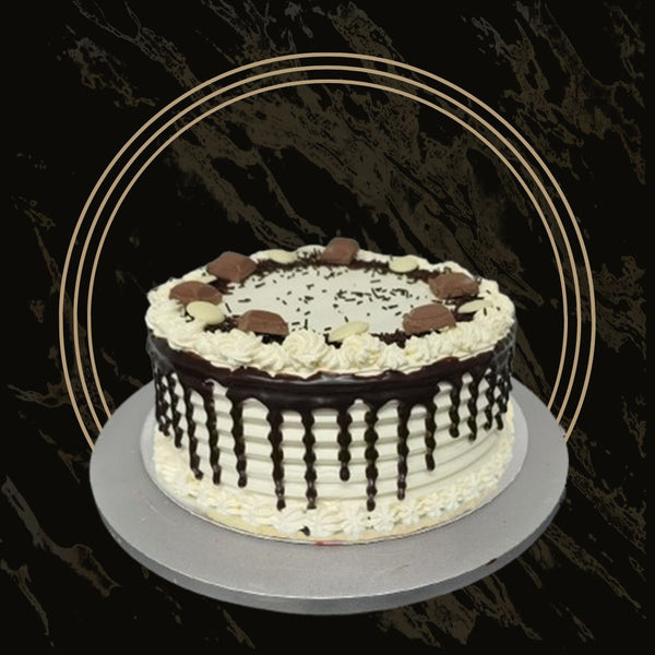 Stylish fancy cake with fresh flowers and smooth buttercream from The Bakers Shop in Birmingham