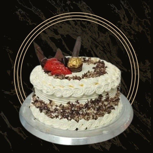 Loaded fancy cake with decorative chocolates, macarons, and shimmer from The Bakers Shop in Birmingham