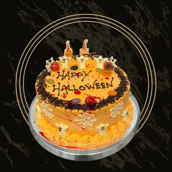 Happy Halloween celebration cake with festive orange and black decorations, pumpkins, and sprinkles from The Bakers Shop in Birmingham