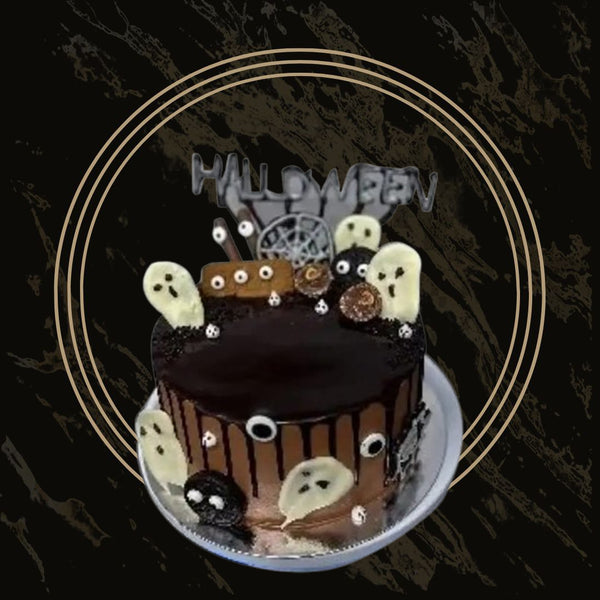 Hauntingly sweet Halloween cake with eerie purple icing, spiderweb design, and edible ghosts from The Bakers Shop in Birmingham