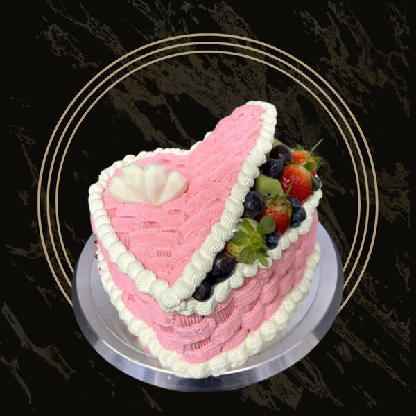 : Classic blue and white celebration cake with elegant piping, floral accents, and smooth buttercream finish from The Bakers Shop in Birmingham