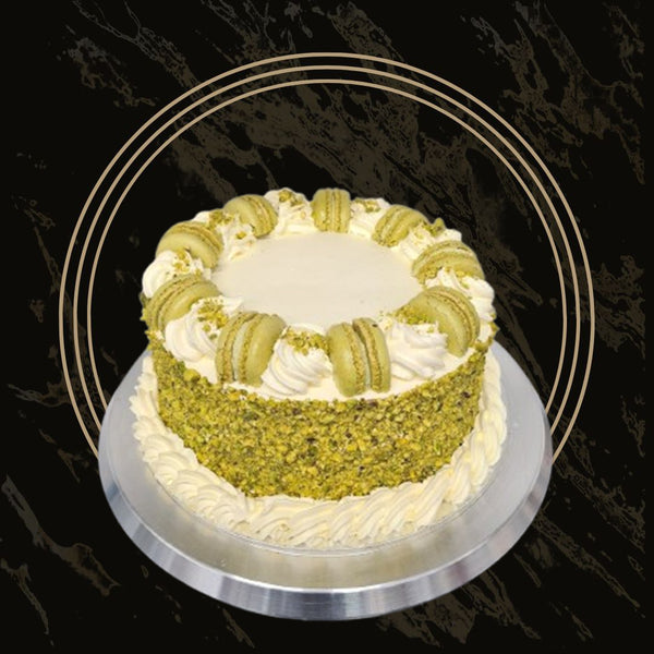 Round pistachio cake with smooth green frosting and crunchy topping from The Bakers Shop in Birmingham