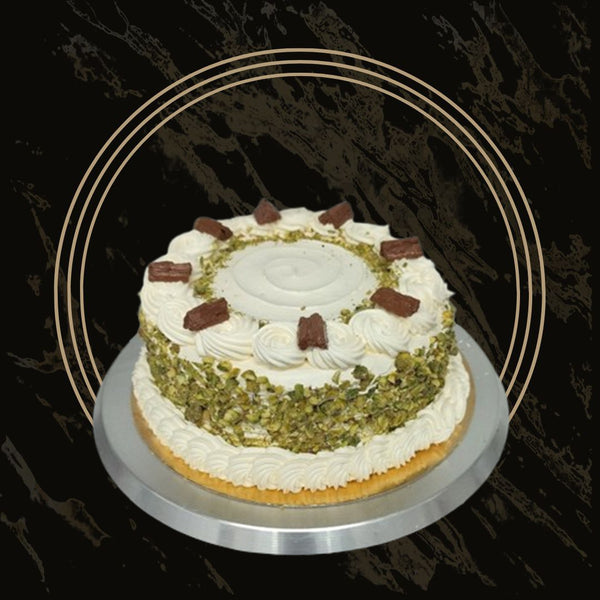 Round pistachio cake with smooth green frosting and crunchy topping from The Bakers Shop in Birmingham