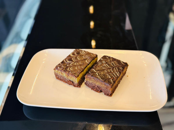 Pistachio Kunafa Brownie – chocolate brownie with pistachio kunafa topping and chocolate drizzle from The Bakers Shop Birmingham