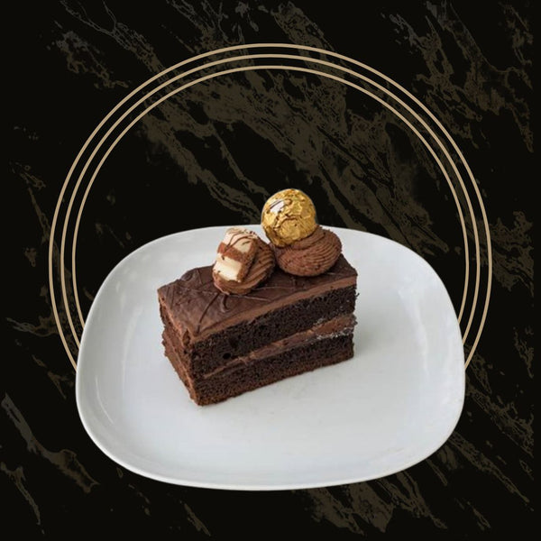 Indulgent triple chocolate cake slices with rich chocolate layers and ganache from The Bakers Shop in Birmingham