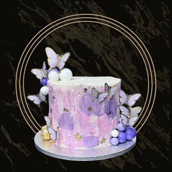 Elegant tiered wedding cake with floral decorations and smooth fondant finish from The Bakers Shop in Birmingham