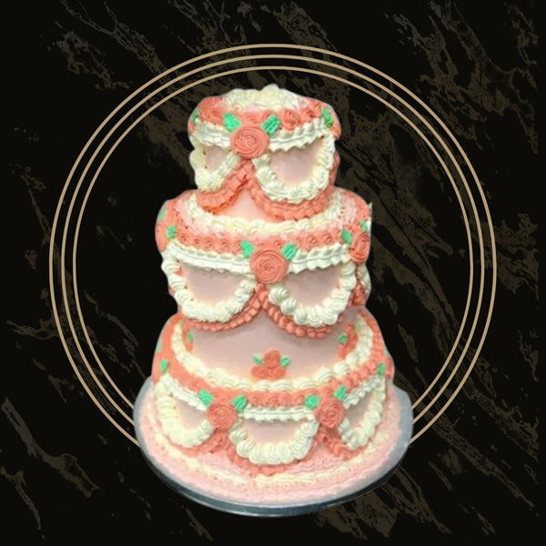 Classic wedding cake decorated with fresh flowers and elegant white buttercream from The Bakers Shop in Birmingham