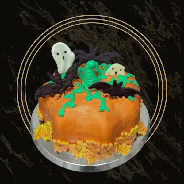 Happy Halloween celebration cake with festive orange and black decorations, pumpkins, and sprinkles from The Bakers Shop in Birmingham