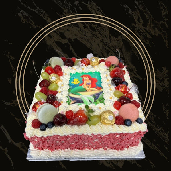 Birthday cake loaded with colorful candies, chocolate pieces, and sprinkles from The Bakers Shop in Birmingham