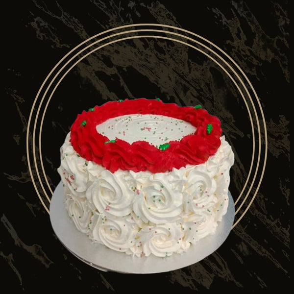 Christmas cake in red and green theme with festive piping and sprinkles from The Bakers Shop in Birmingham