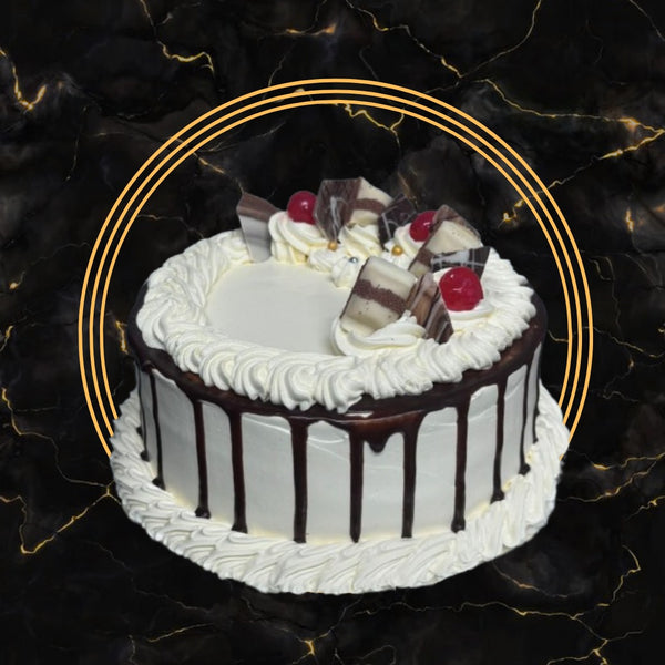 Fresh cream cake with chocolate drip, cream swirls, cherries, and chocolate decoration