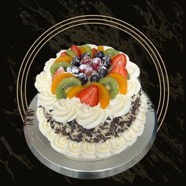 Round fruit cake with glossy fruit topping and sponge base from The Bakers Shop in Birmingham