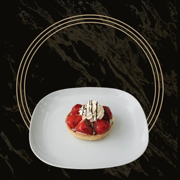 Fresh strawberry tart with a buttery crust and smooth cream filling from The Bakers Shop in Birmingham